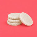 Four round, porous reuseable white sponges